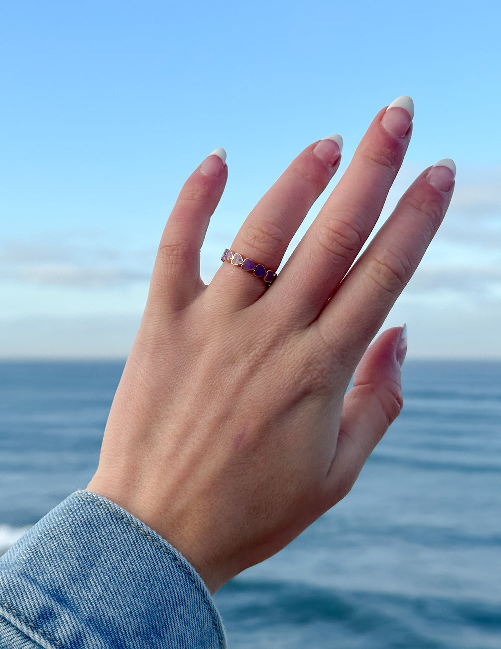 Silver-tone ring with purple heart infinity motif on a slim band