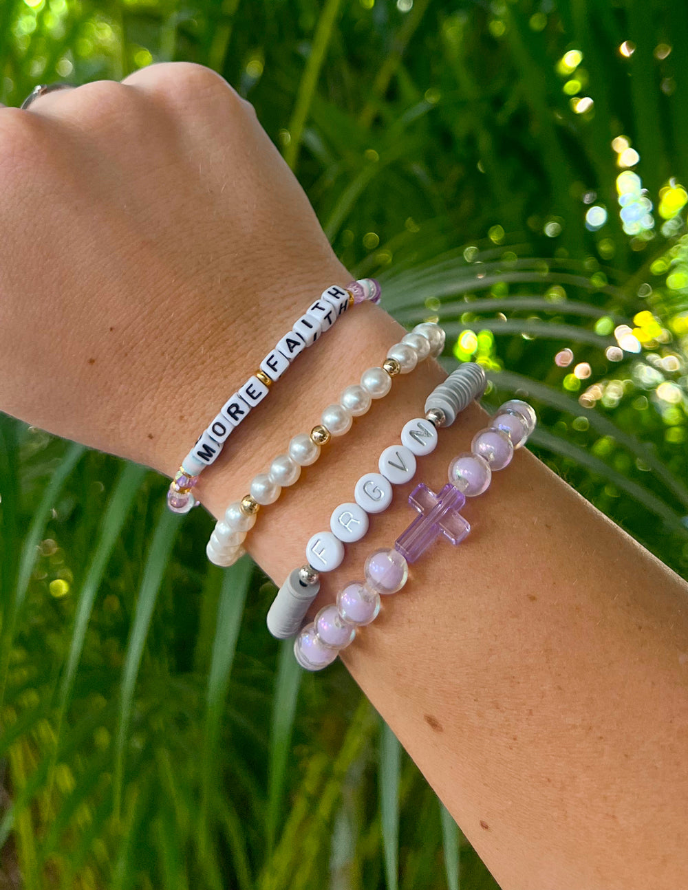 Beaded letter bracelet with alphabet beads and pearl-style beads on wrist