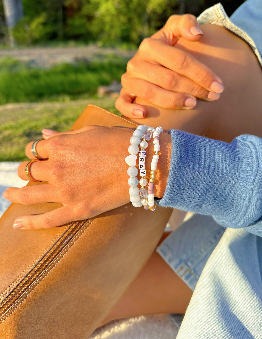 Pearl beaded bracelet with letter beads spelling PRAY, pink and gold accents