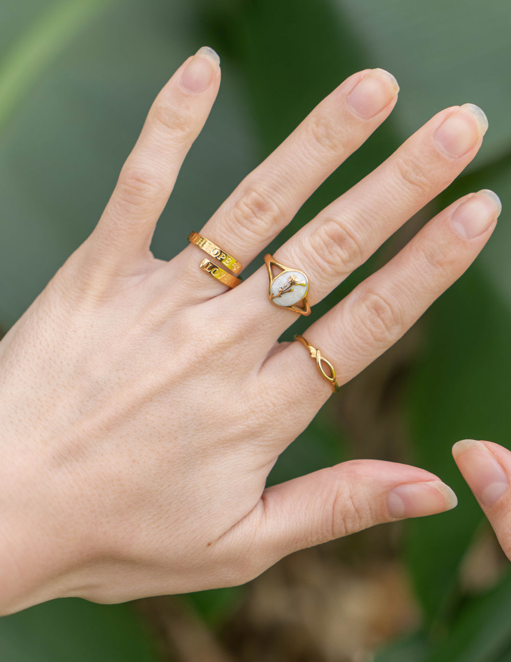 Gold-tone oval signet ring with white cameo and butterfly detail