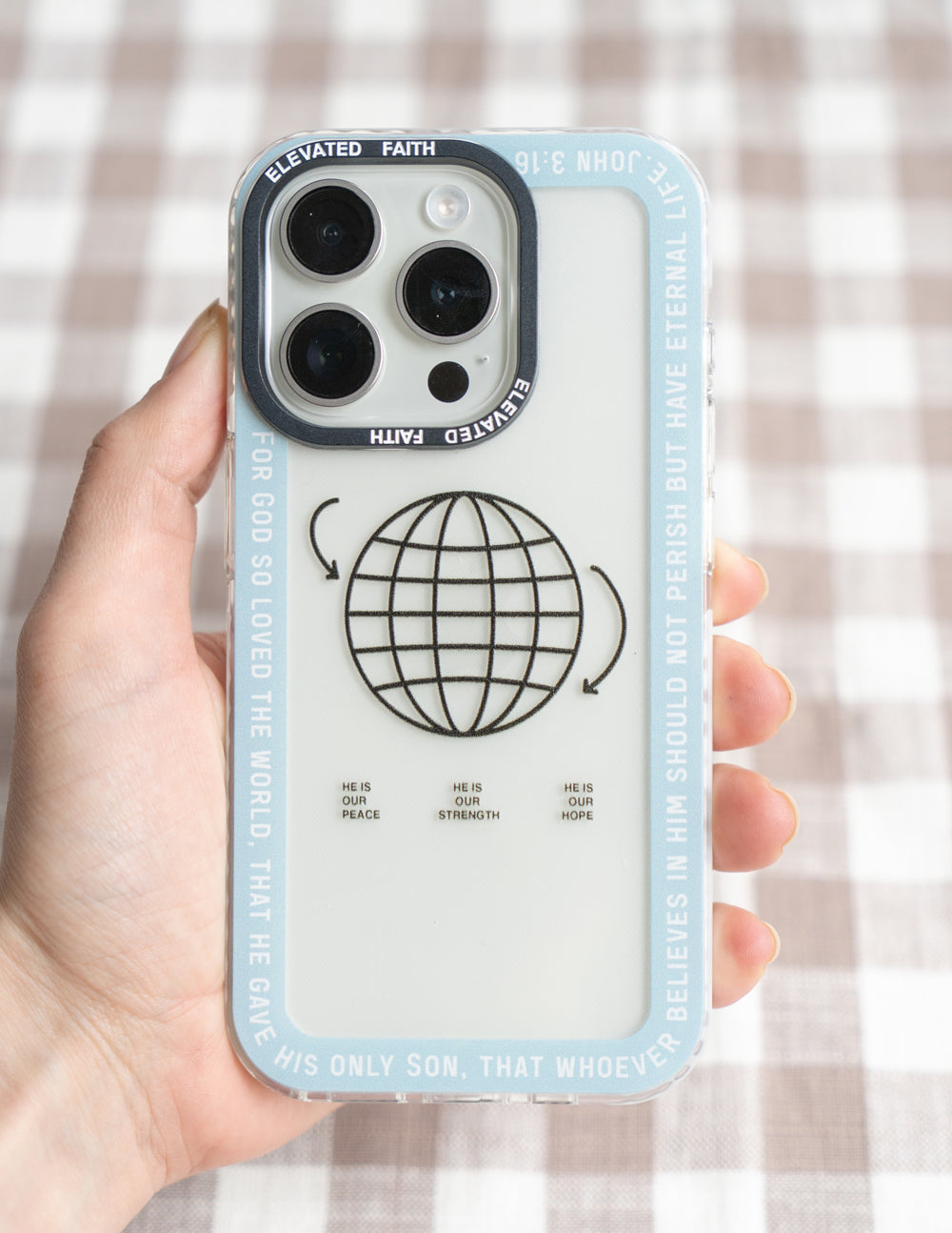 Light blue phone case with black globe icon and small faith words in rows