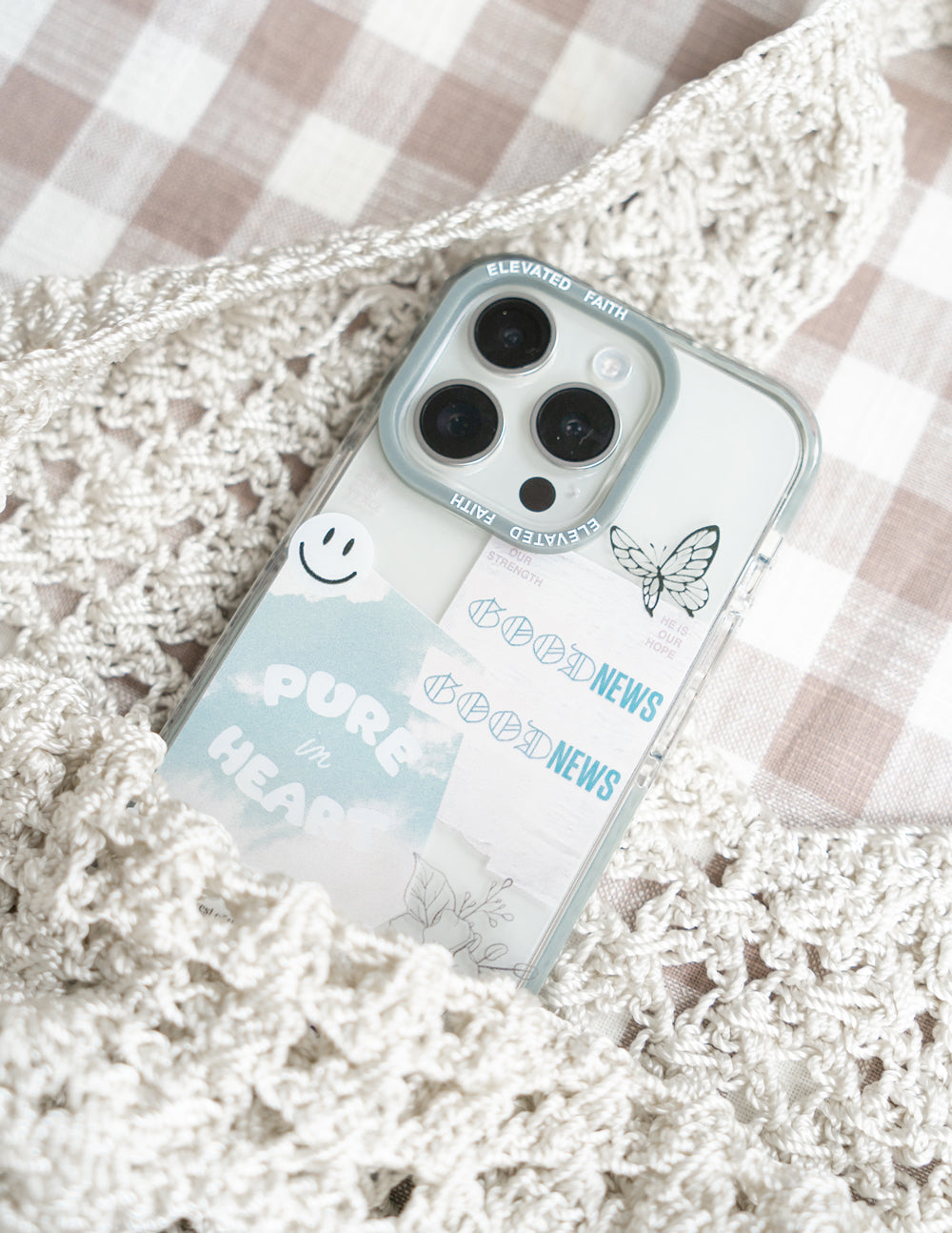 Transparent phone case with light blue border, butterfly print and faith-themed text