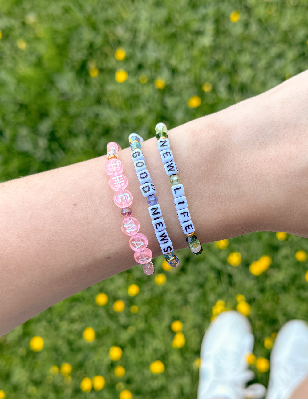 Blue and white beaded 'NEW LIFE' bracelet with letter beads and gold accents