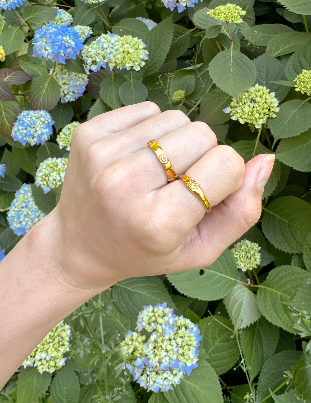 Gold ring with blue enamel center, close view on hand