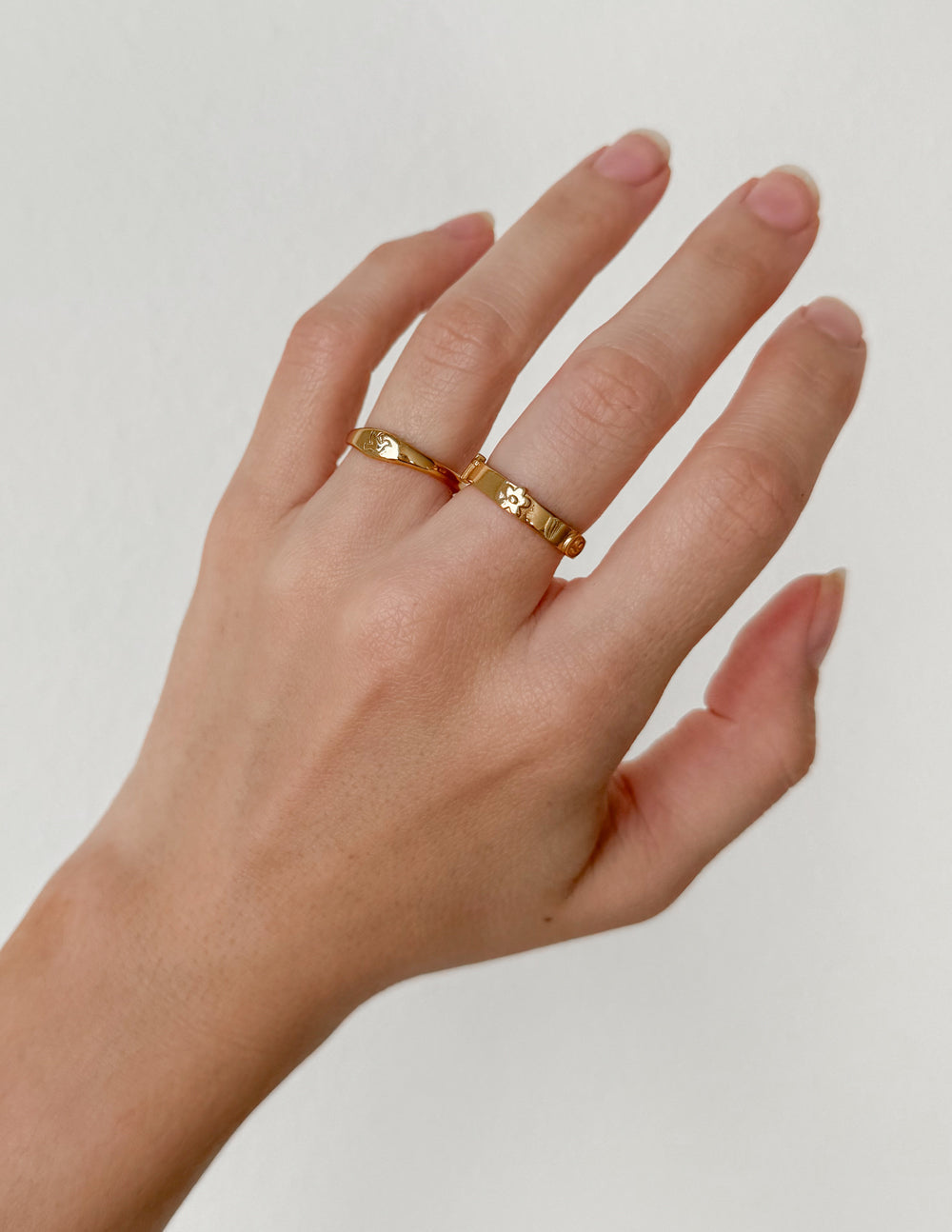 Gold ring with small cross charms and decorative band
