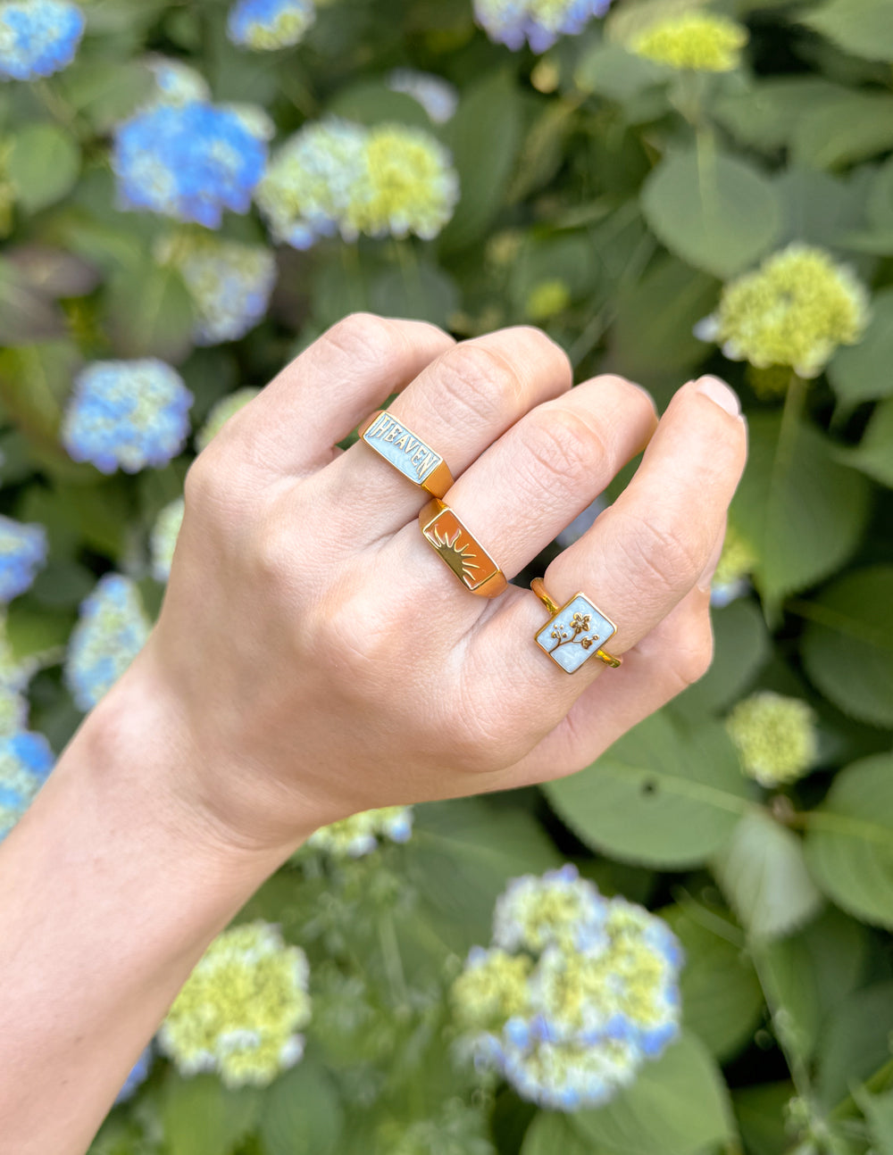 Gold rectangular signet ring with blue enamel top and engraved HEAVEN
