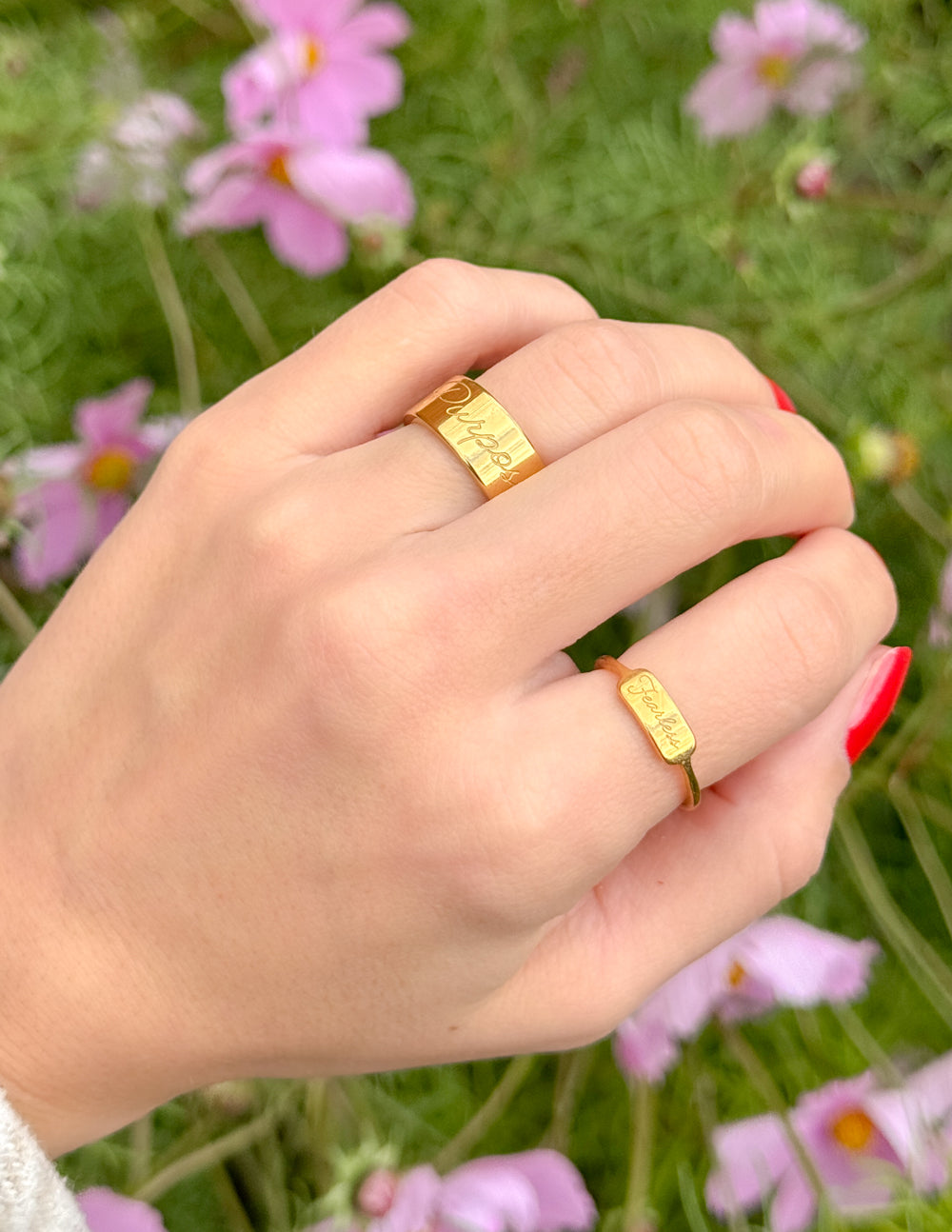Gold Fearless signet ring on finger, stacked with slim band