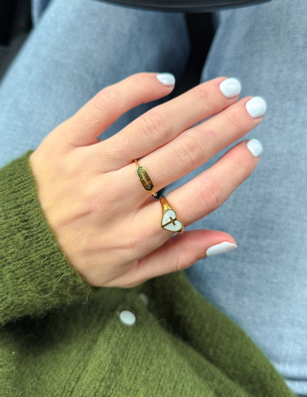 Gold heart cross ring with light blue enamel and green accents on band