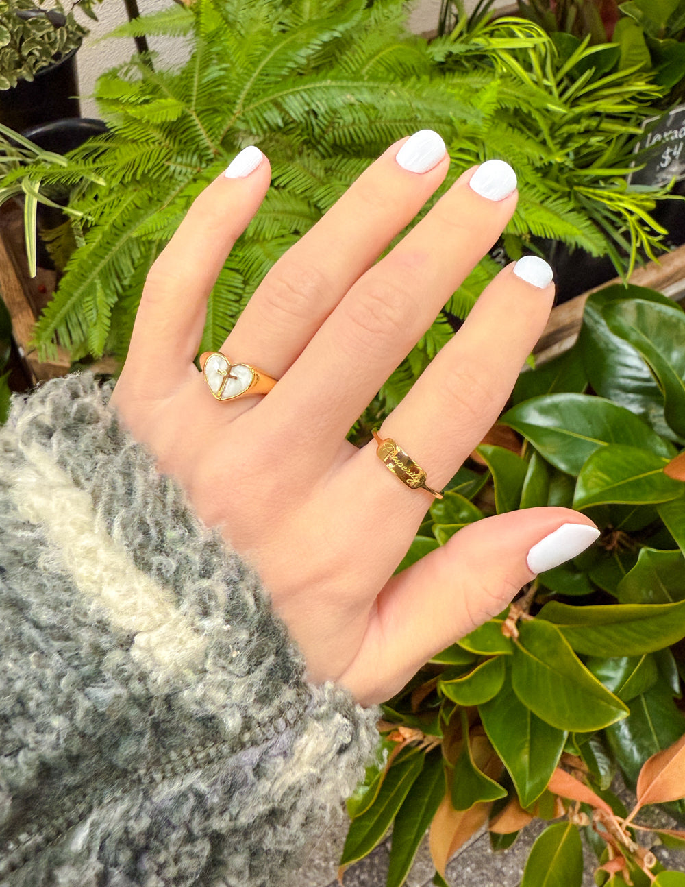 Gold enamel heart cross ring worn on finger with raised heart and cross
