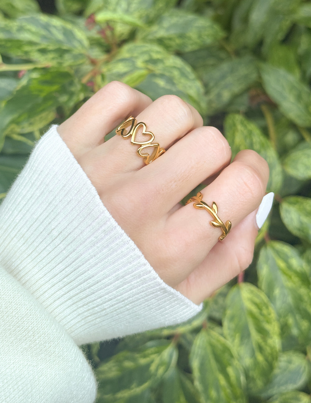Gold-tone olive branch ring with curled vine leaves on an open band