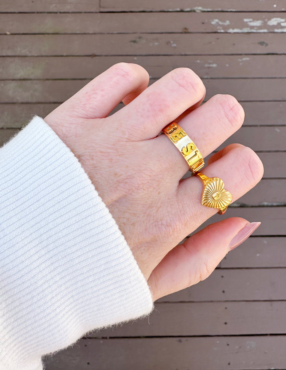 Gold-tone floral signet ring with engraved floral face on fingertip