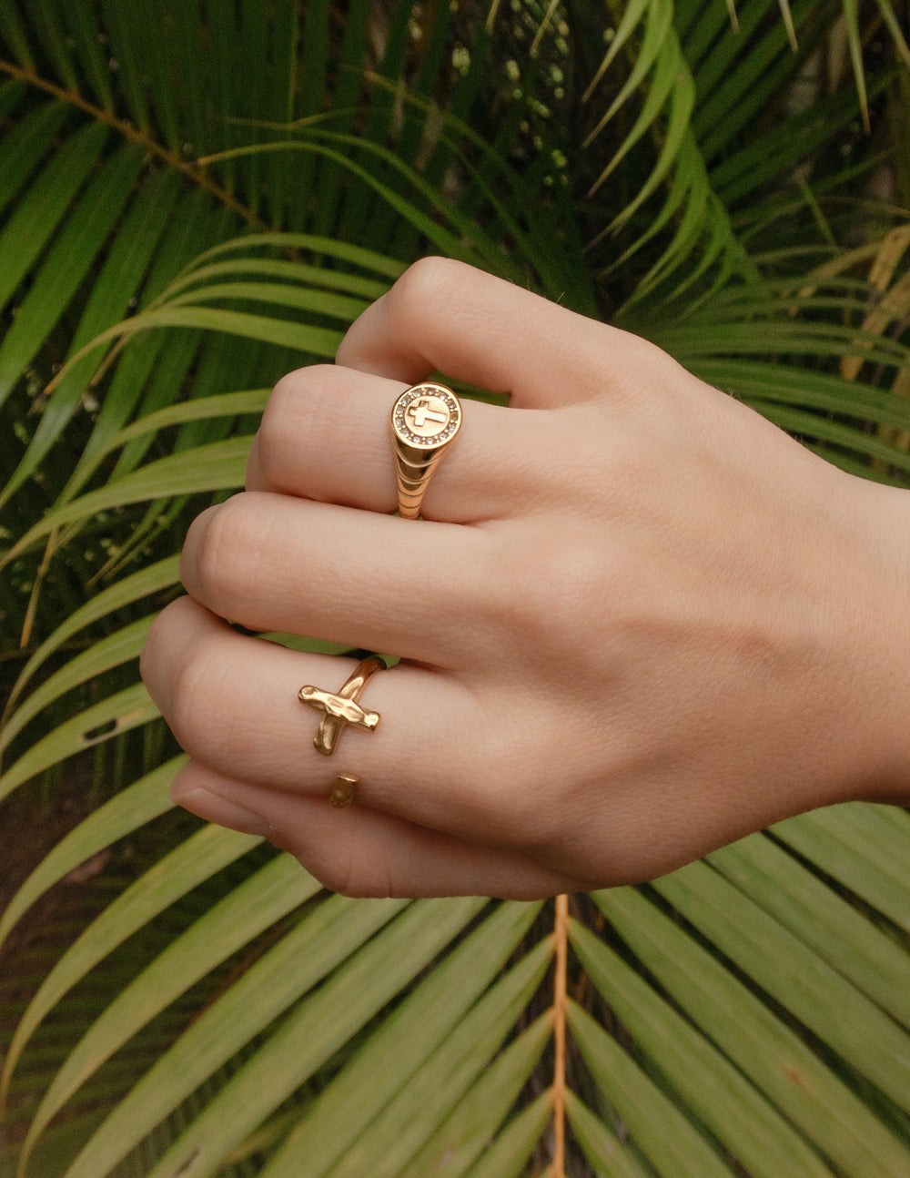 Gold textured band cross ring worn on finger
