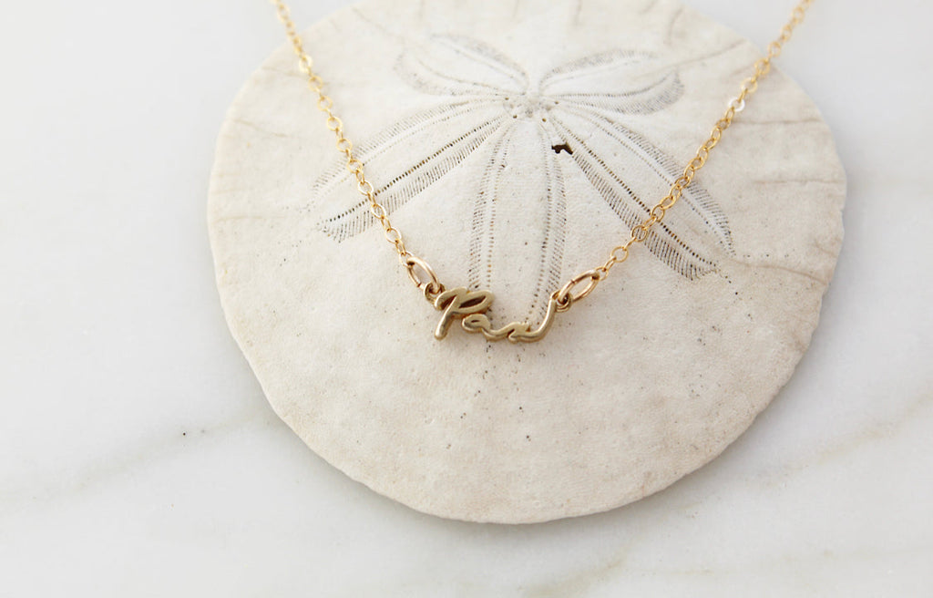 Gold Pax necklace with cursive script pendant on chain