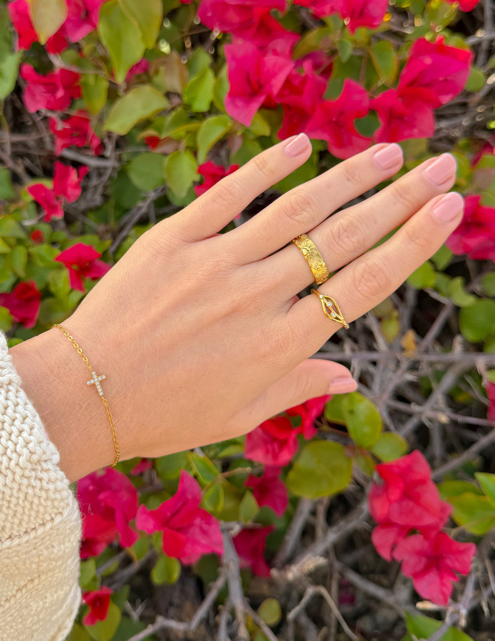 Gold-tone celestial-pattern ring on hand, textured band and engraved details