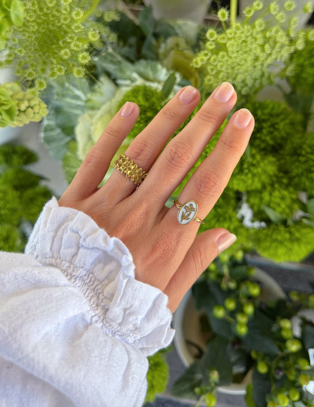 Gold-tone shield-pattern ring with raised edges on finger