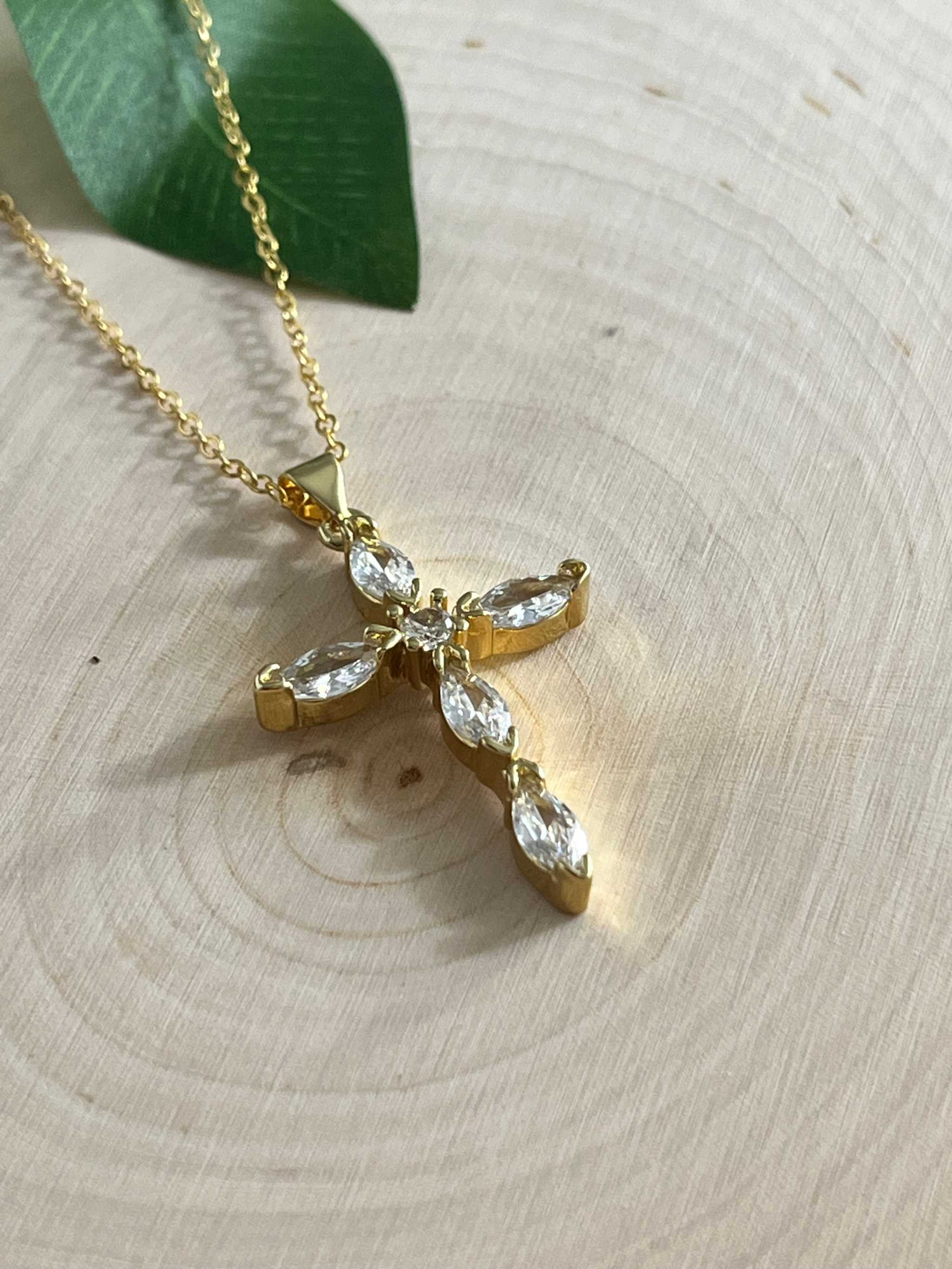 Gold cross pendant necklace with faceted crystal cross detail on a thin chain