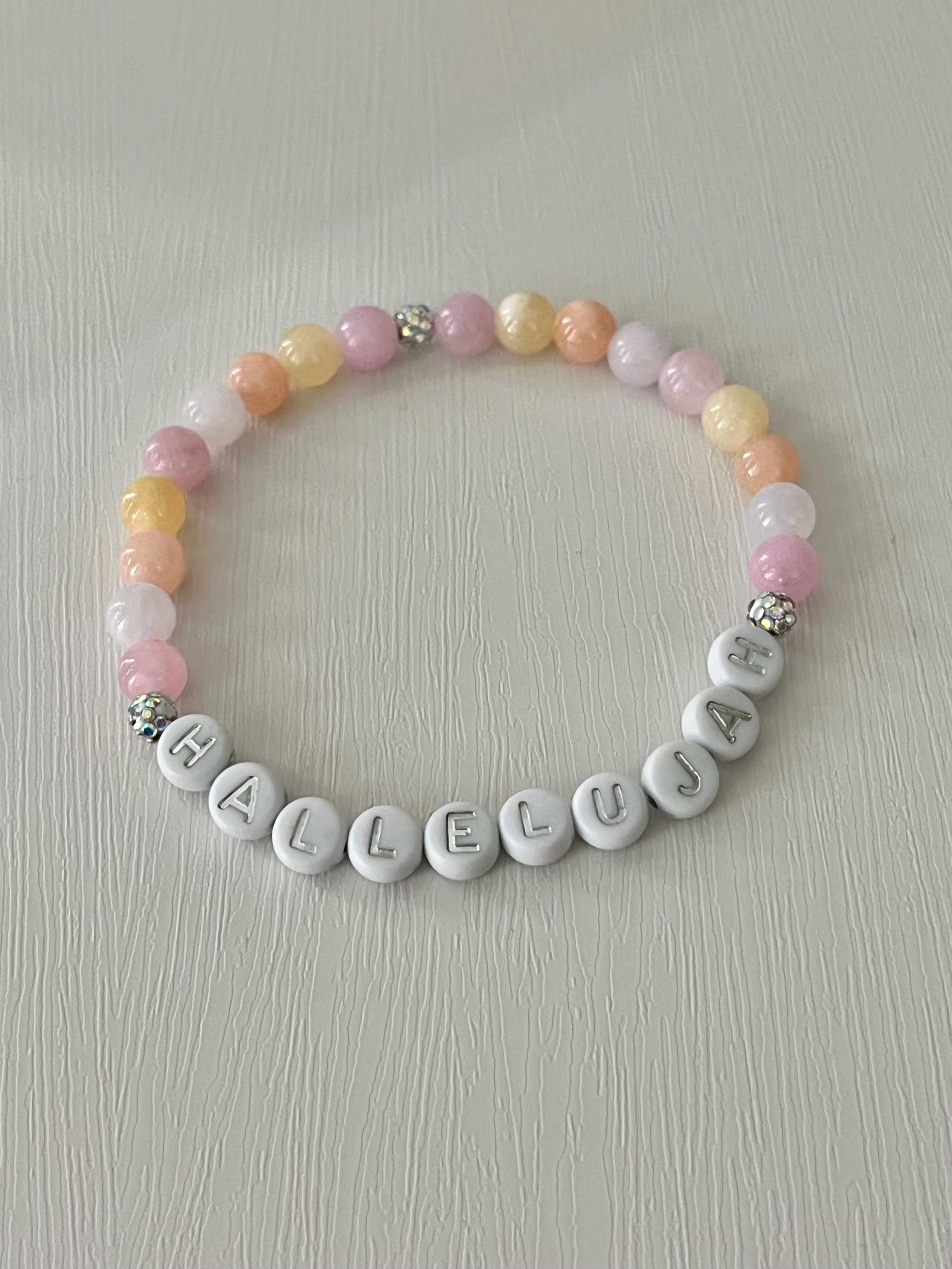 Beaded bracelet with pastel round beads and silver letter beads spelling HALLELUJAH