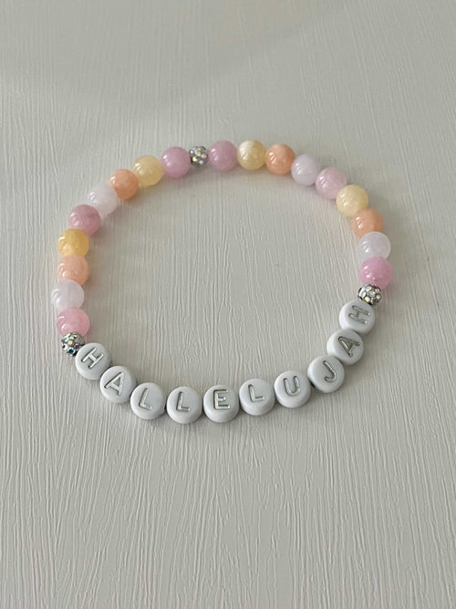 Beaded bracelet with pastel round beads and silver letter beads spelling HALLELUJAH