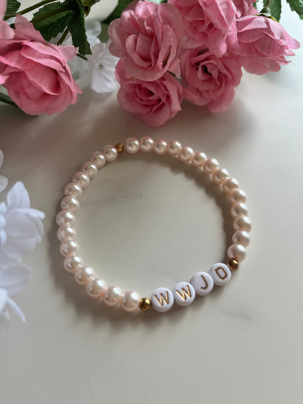 Cream pink pearl bead bracelet with WWJD letter beads and gold accent caps