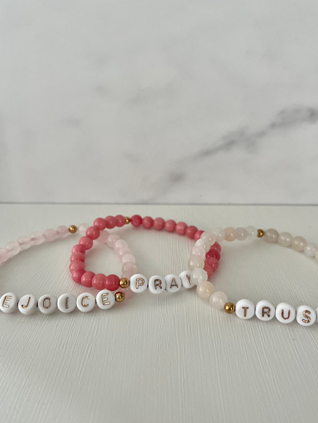 Beaded bracelet set with red Pray beads and cream Trust beads, gold accents