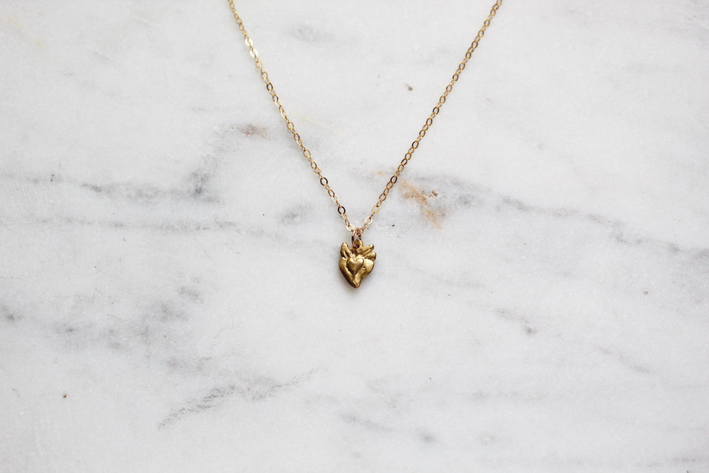 Gold sacred heart pendant necklace on a fine chain