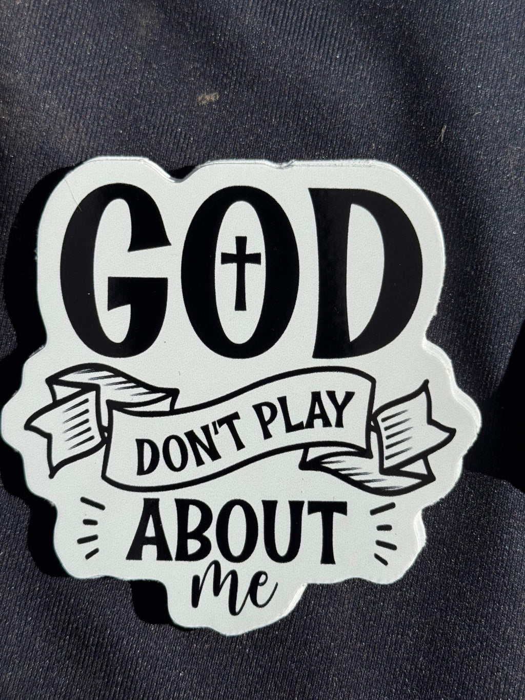 Vinyl sticker with 'GOD' cross and 'DON’T PLAY ABOUT me' text