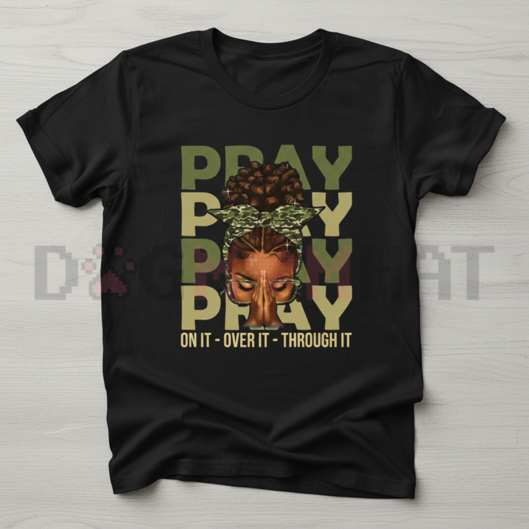 Black crewneck T-shirt with centered “PRAY” graphic and crown face illustration