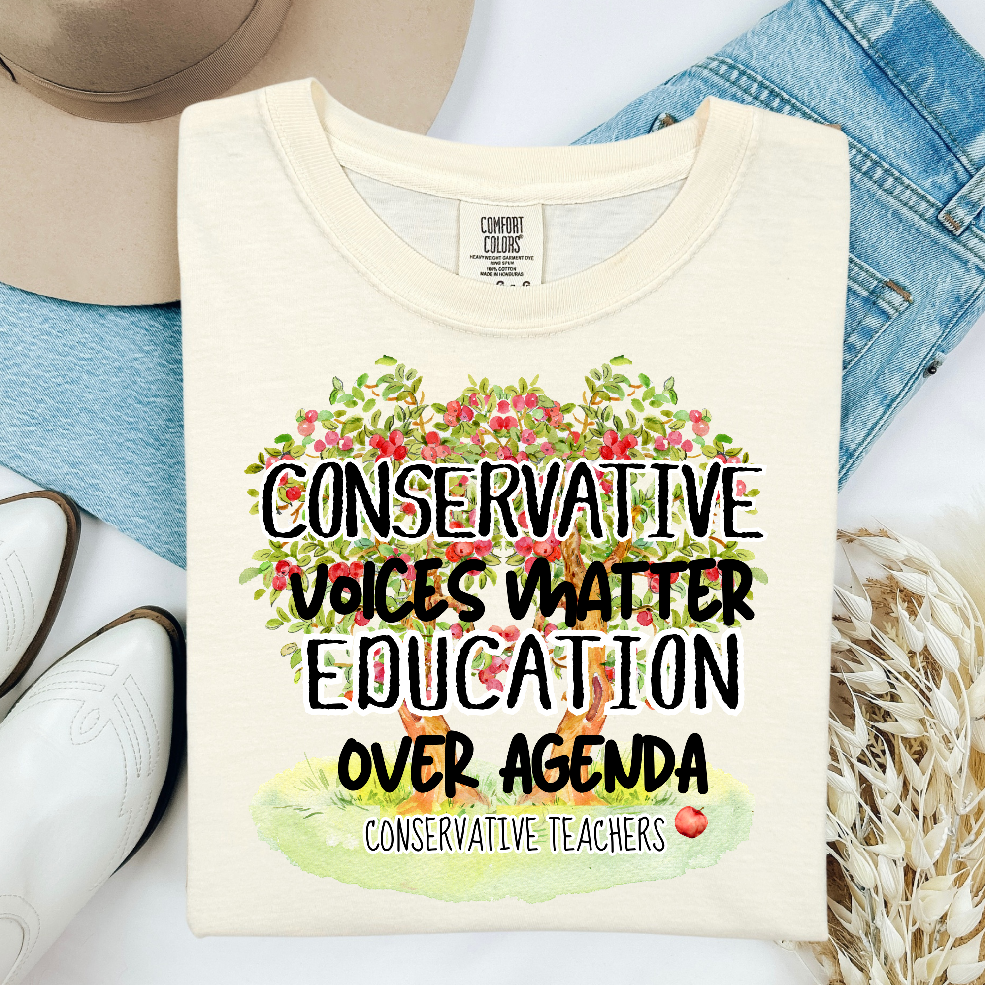 Ivory Comfort Colors T-shirt with colorful education graphic and slogan over agenda