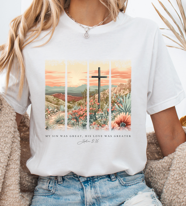 White graphic T-shirt with cross over desert landscape and scripture text below
