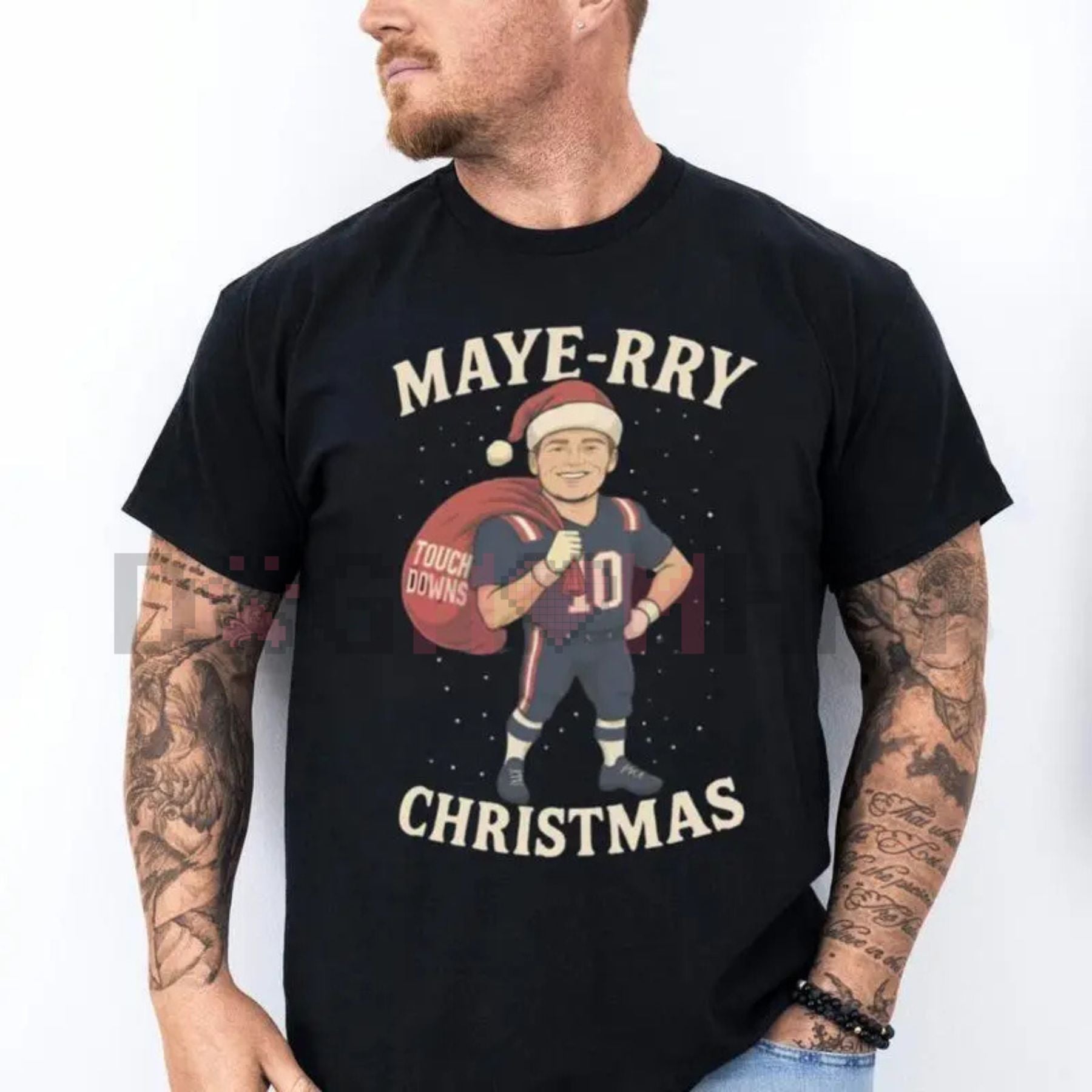 Dark T-shirt with centered MAYE-RRY football Christmas graphic and CHRISTMAS text