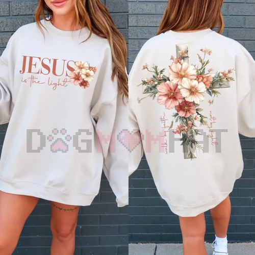 White crewneck sweatshirt with floral cross graphic and “Jesus is the light” lettering