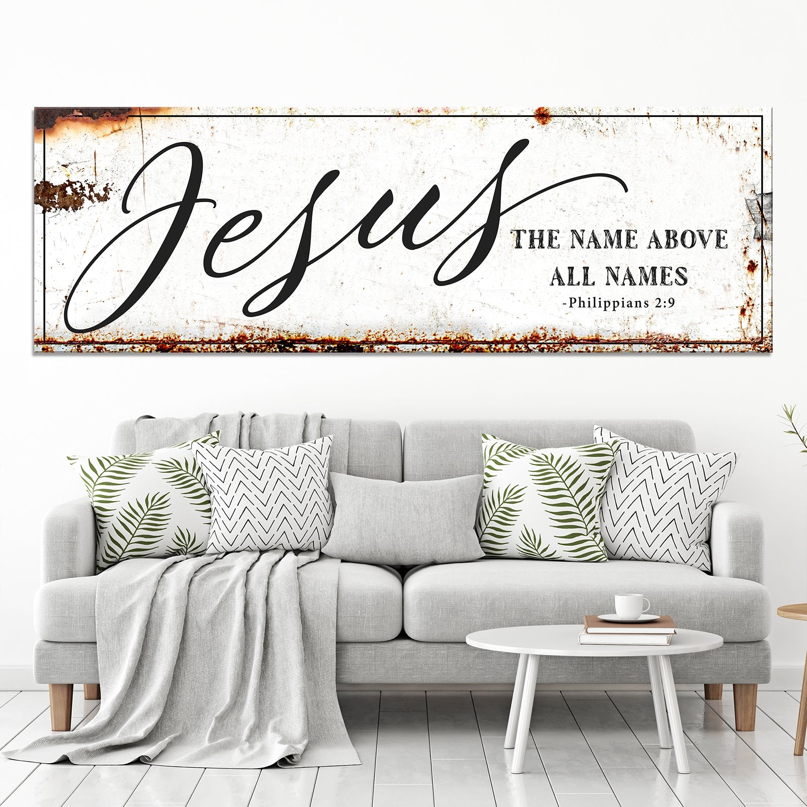 Framed Jesus wall art above sofa with 'The name above all names' and 'Philippians 2:9'