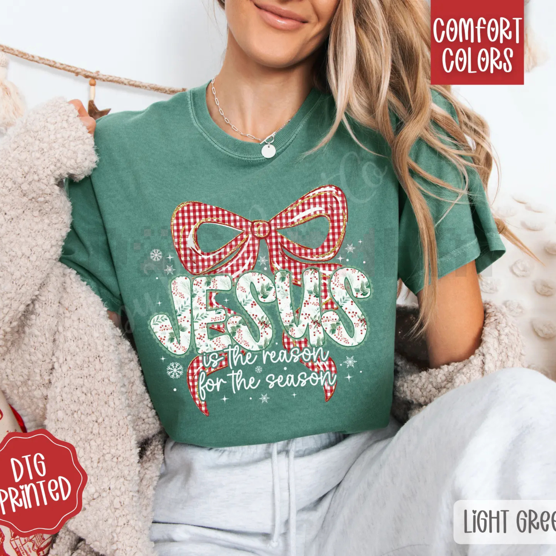 Green crewneck tee with red plaid bow and festive lettering graphic