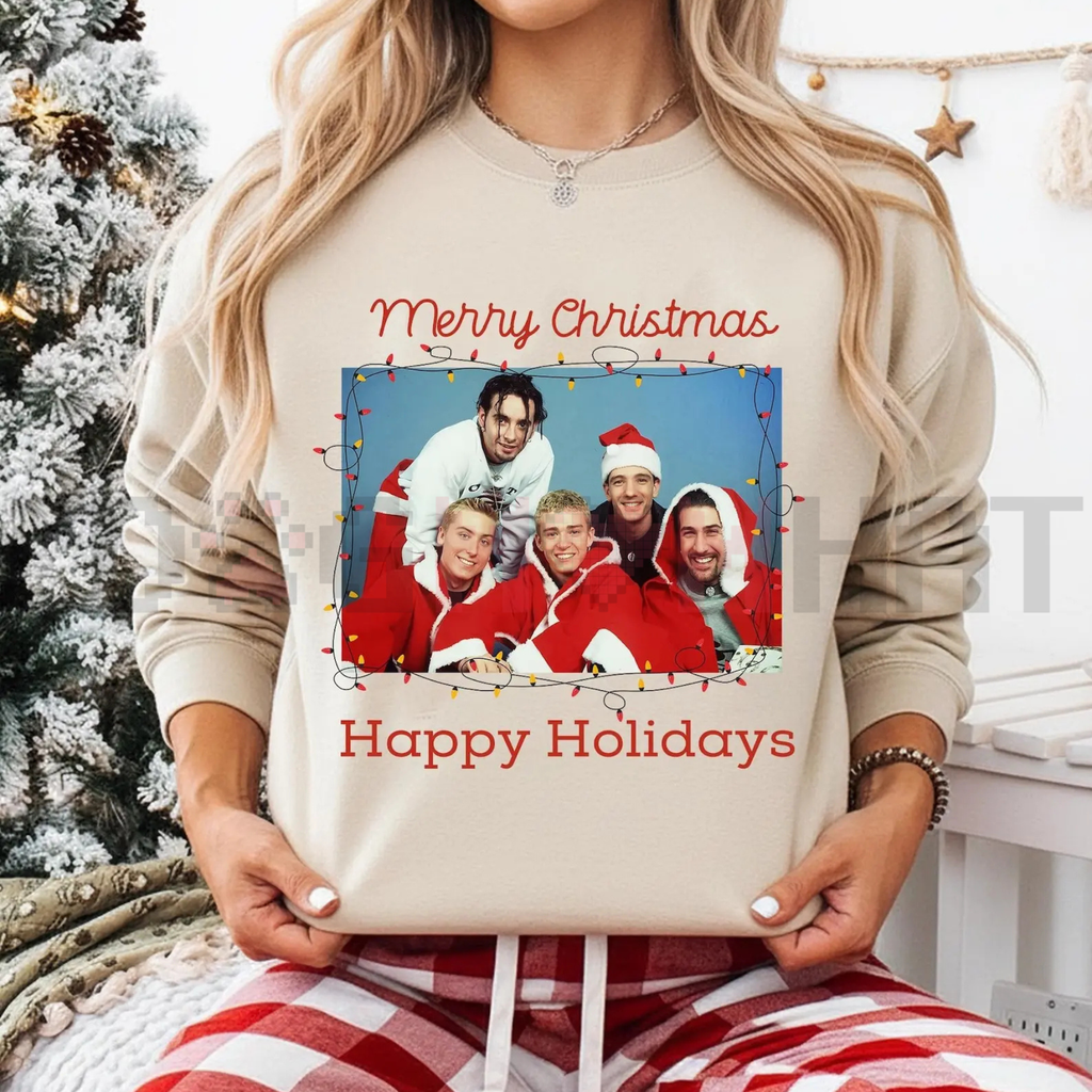 Cream crewneck sweatshirt with Christmas group graphic and red 'Happy Holidays' text