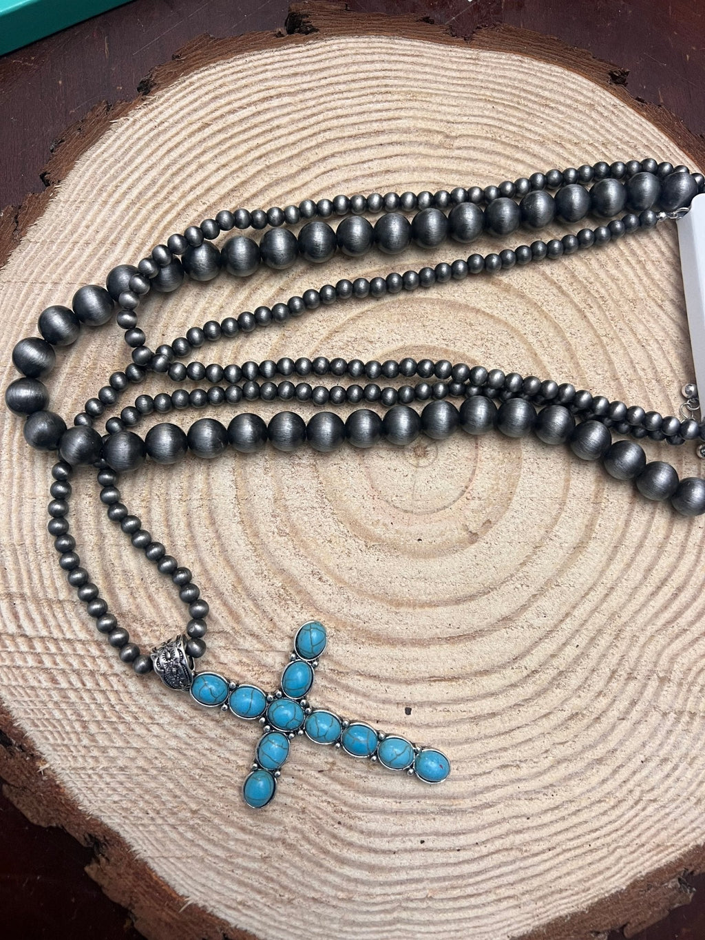 Three-layer dark faux-pearl bead necklace with turquoise cross pendant