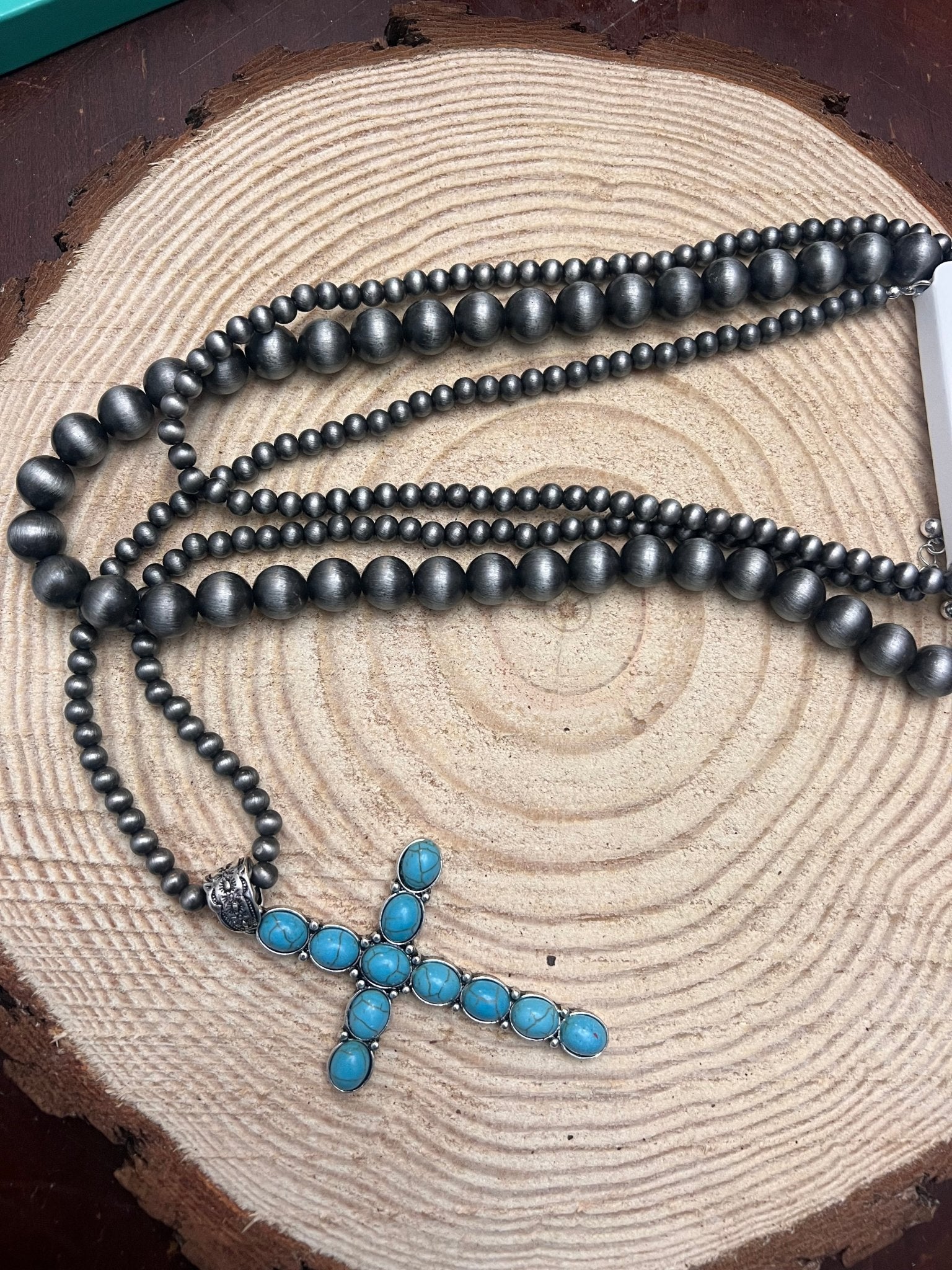 Three-layer dark faux-pearl bead necklace with turquoise cross pendant