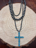 Three-layer cross necklace with dark faux-pearl beads and turquoise cross pendant