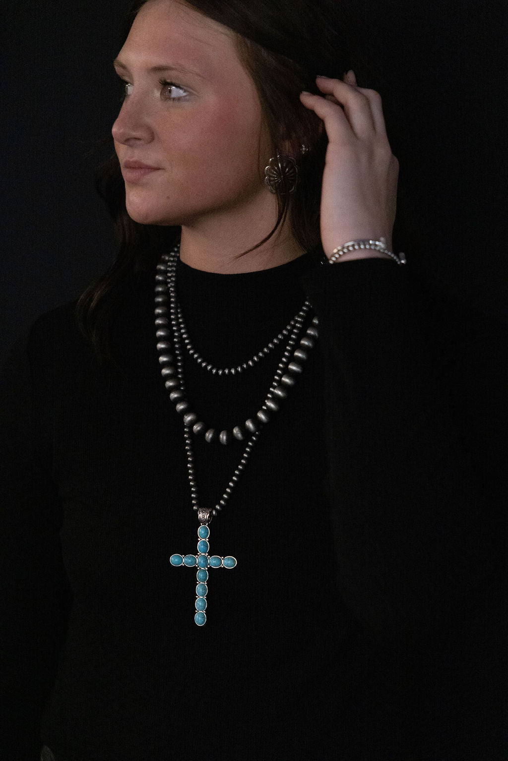 Three-layer cross necklace with turquoise cross pendant on dark bead strands