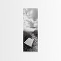 Canvas print of open Bible on a sandy beach path under cloudy sky
