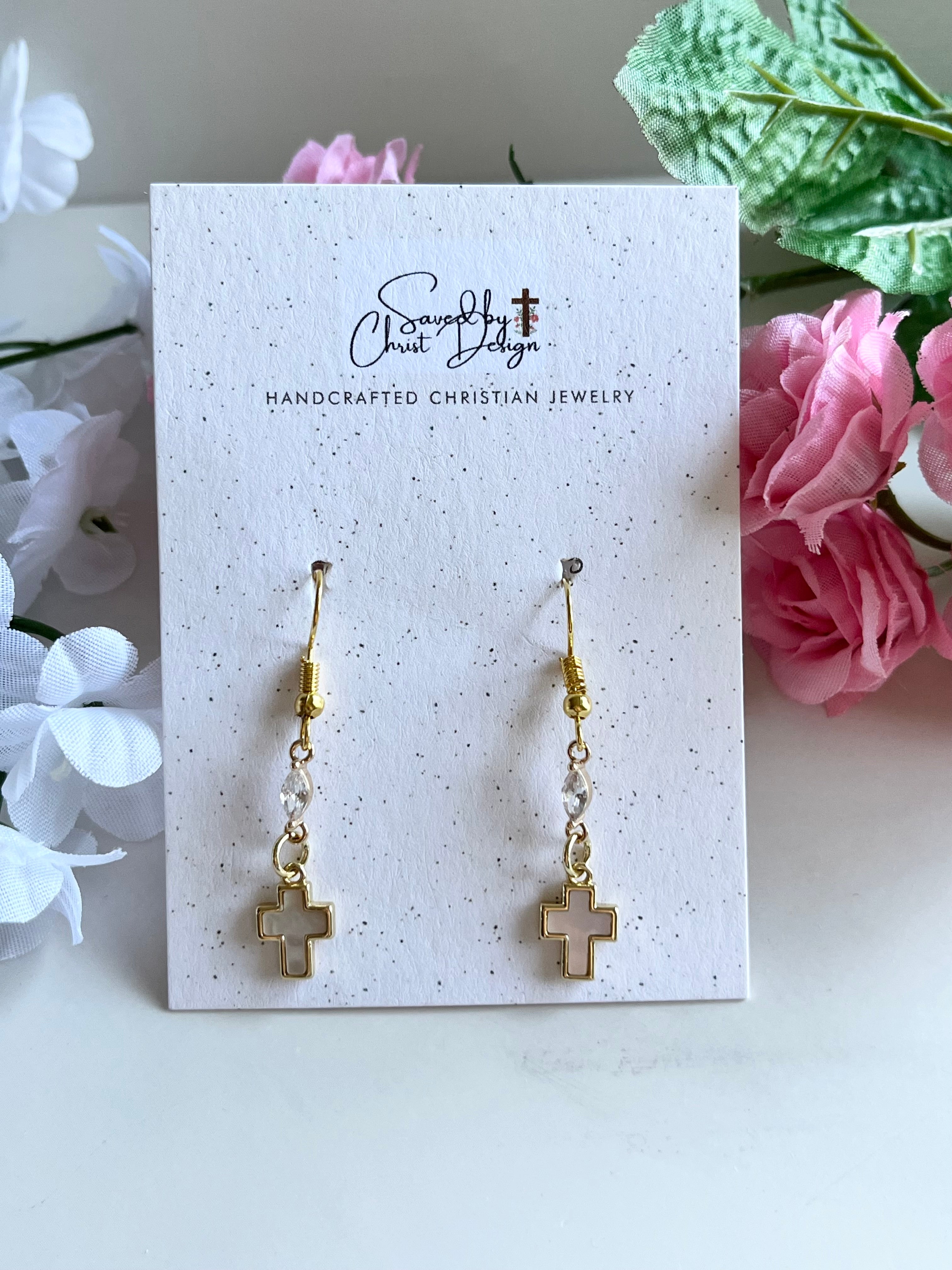 Gold-tone cross drop earrings on card, pair with dangling cross charms.