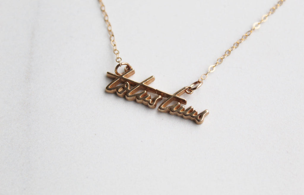 Gold-tone Totus Tuus script pendant necklace, side angle close-up