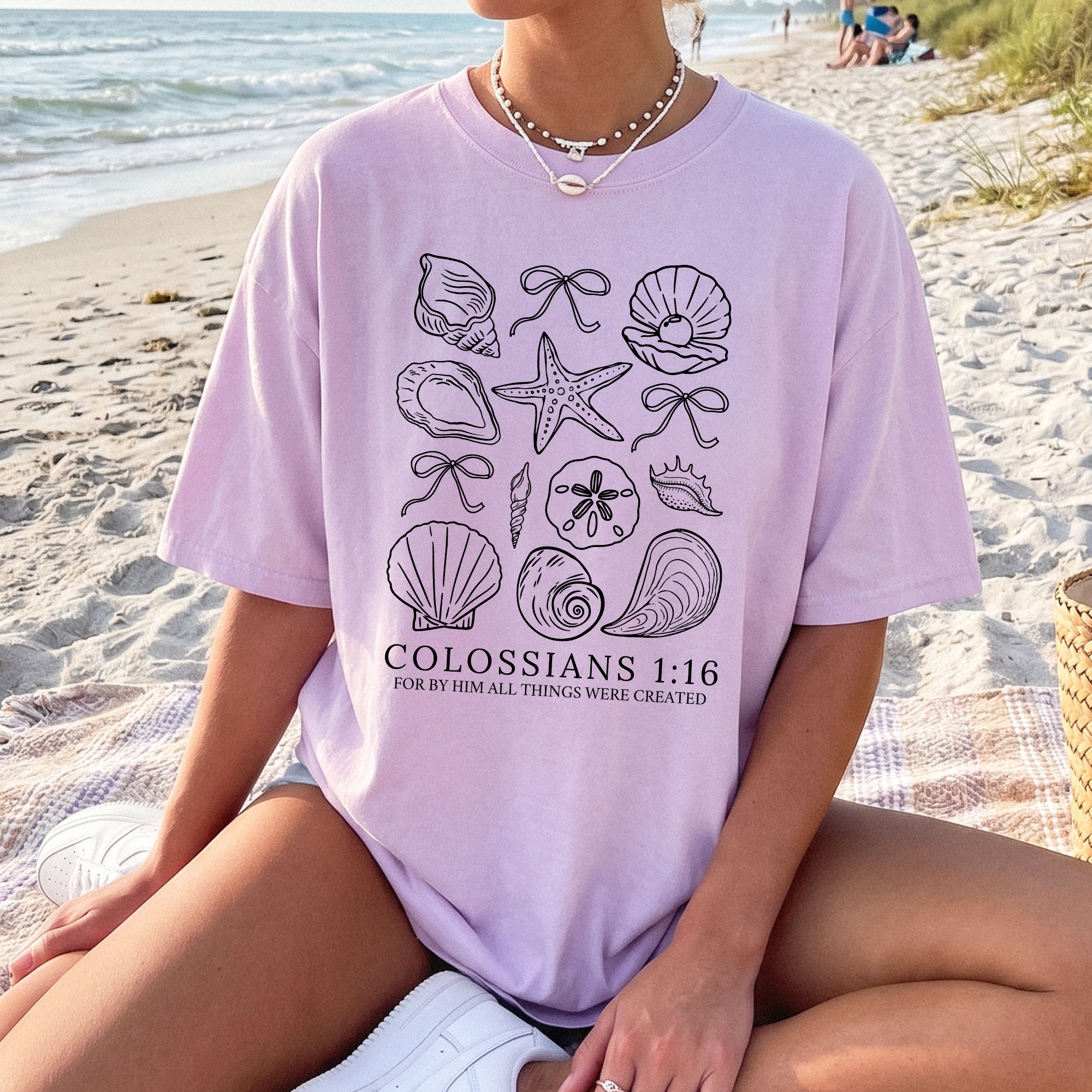 Women's lavender Christian graphic T-shirt with seashell artwork and 'Colossians 1:16' slogan