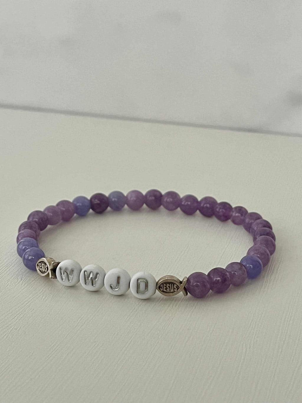 Purple bead bracelet with WWJD letter beads and Jesus faith charm