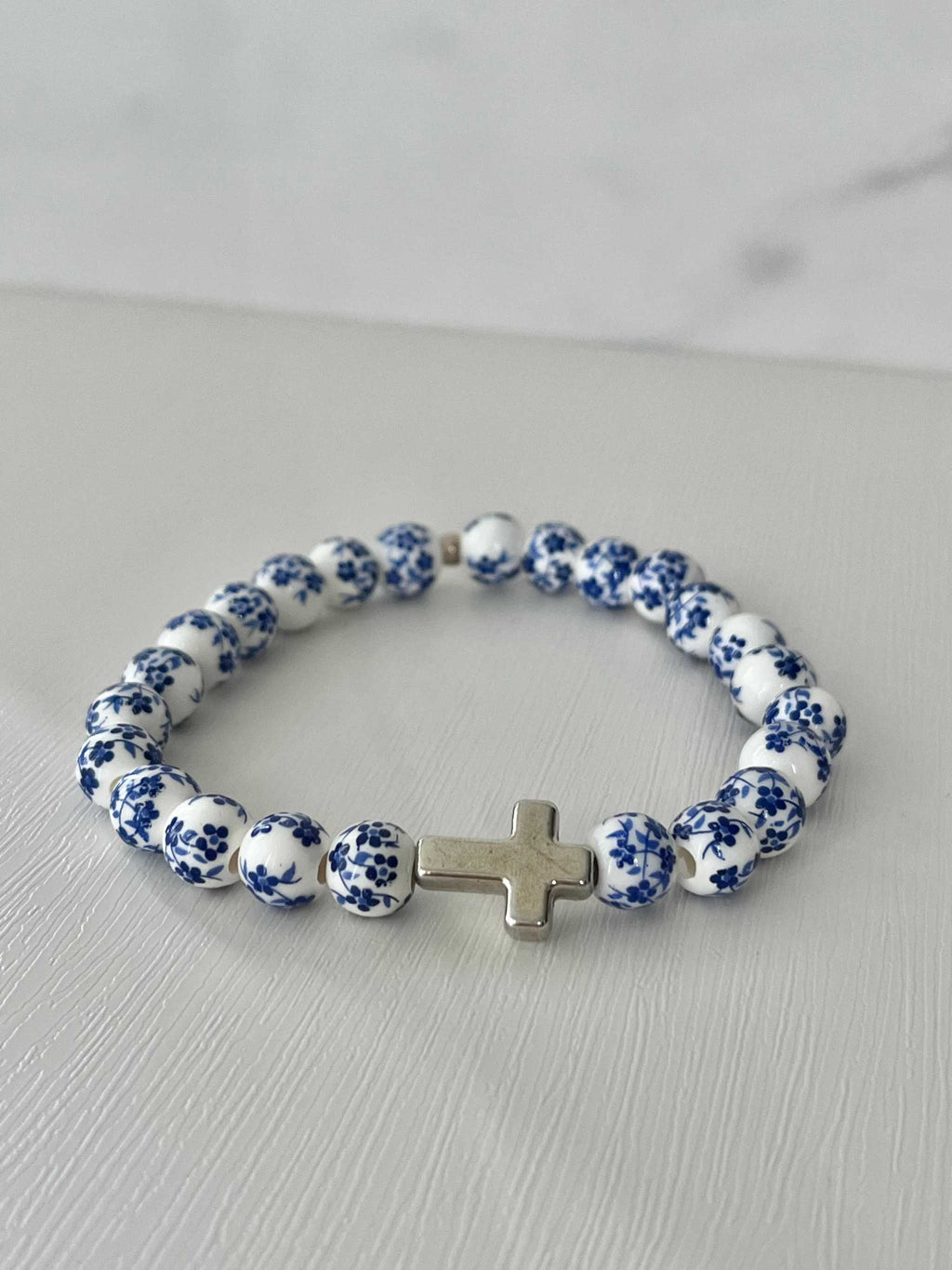 Blue and white beaded cross bracelet with silver cross charm