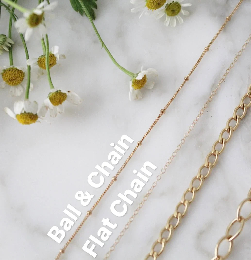 Gold-tone necklace chains with small links, cross charm not visible