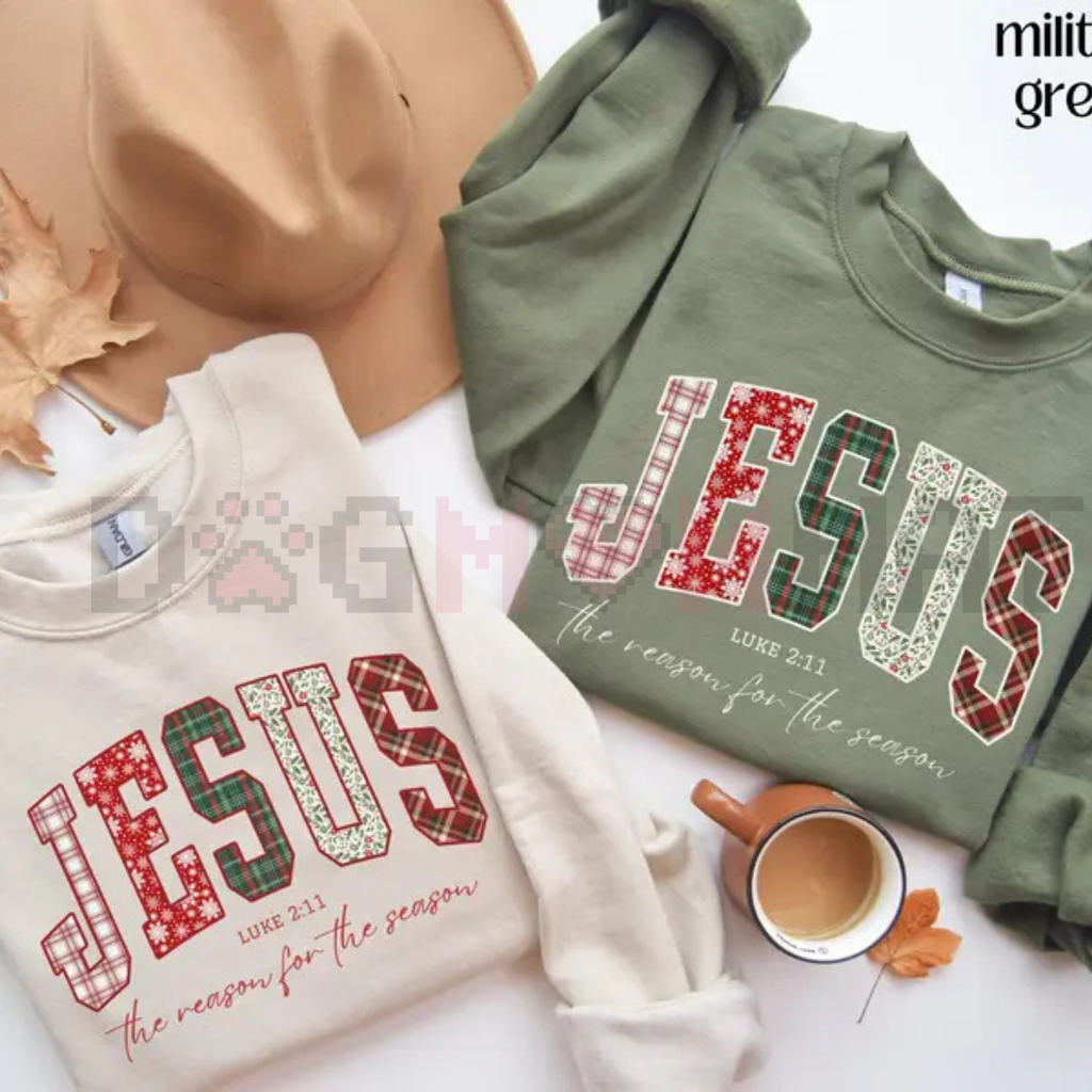 Green and white crewneck sweatshirts with red “JESUS” holiday graphic