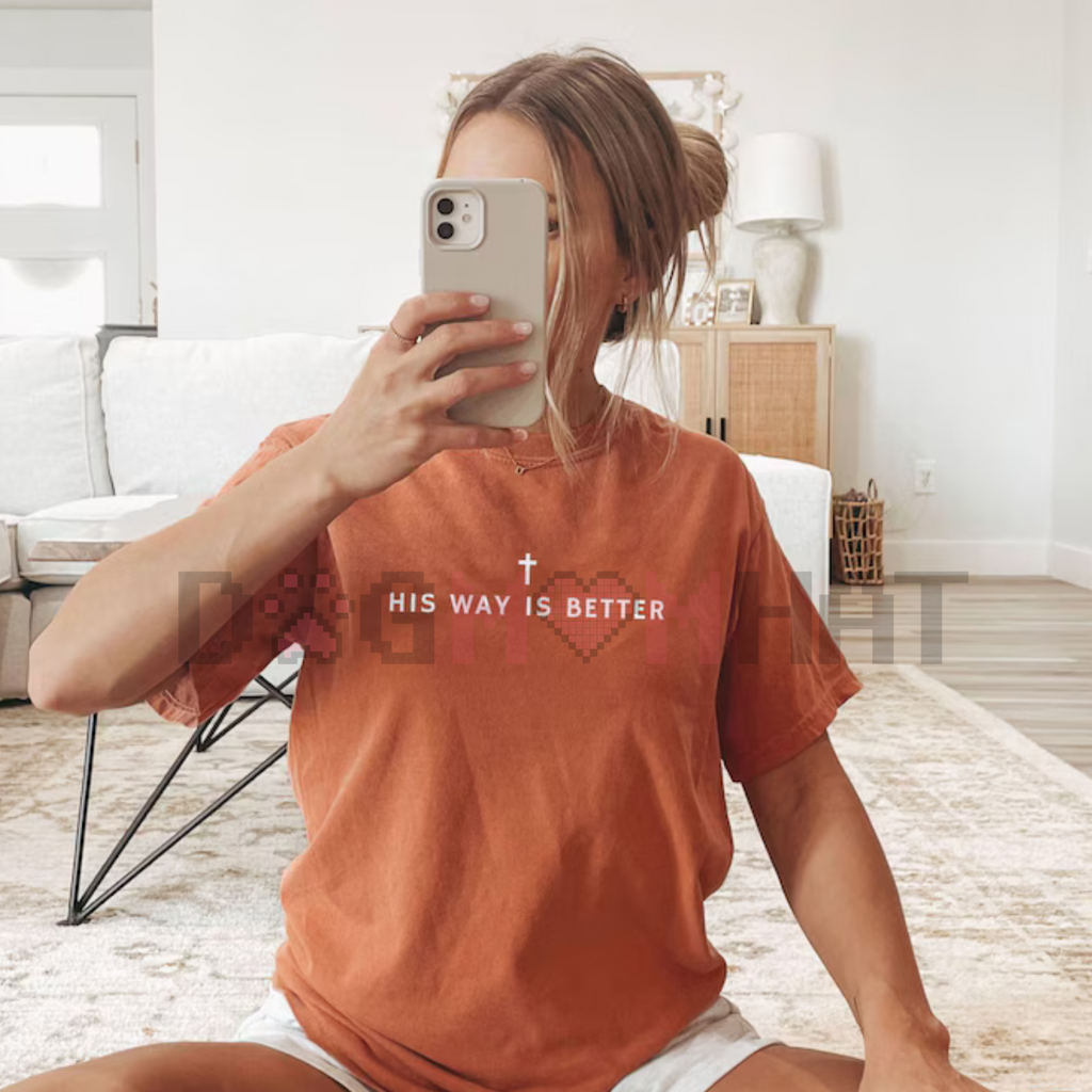 Orange crewneck T-shirt with short sleeves and centered text with cross graphic