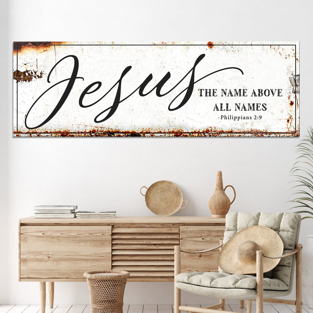 Framed Jesus wall art above console with 'The name above all names' and 'Philippians 2:9'