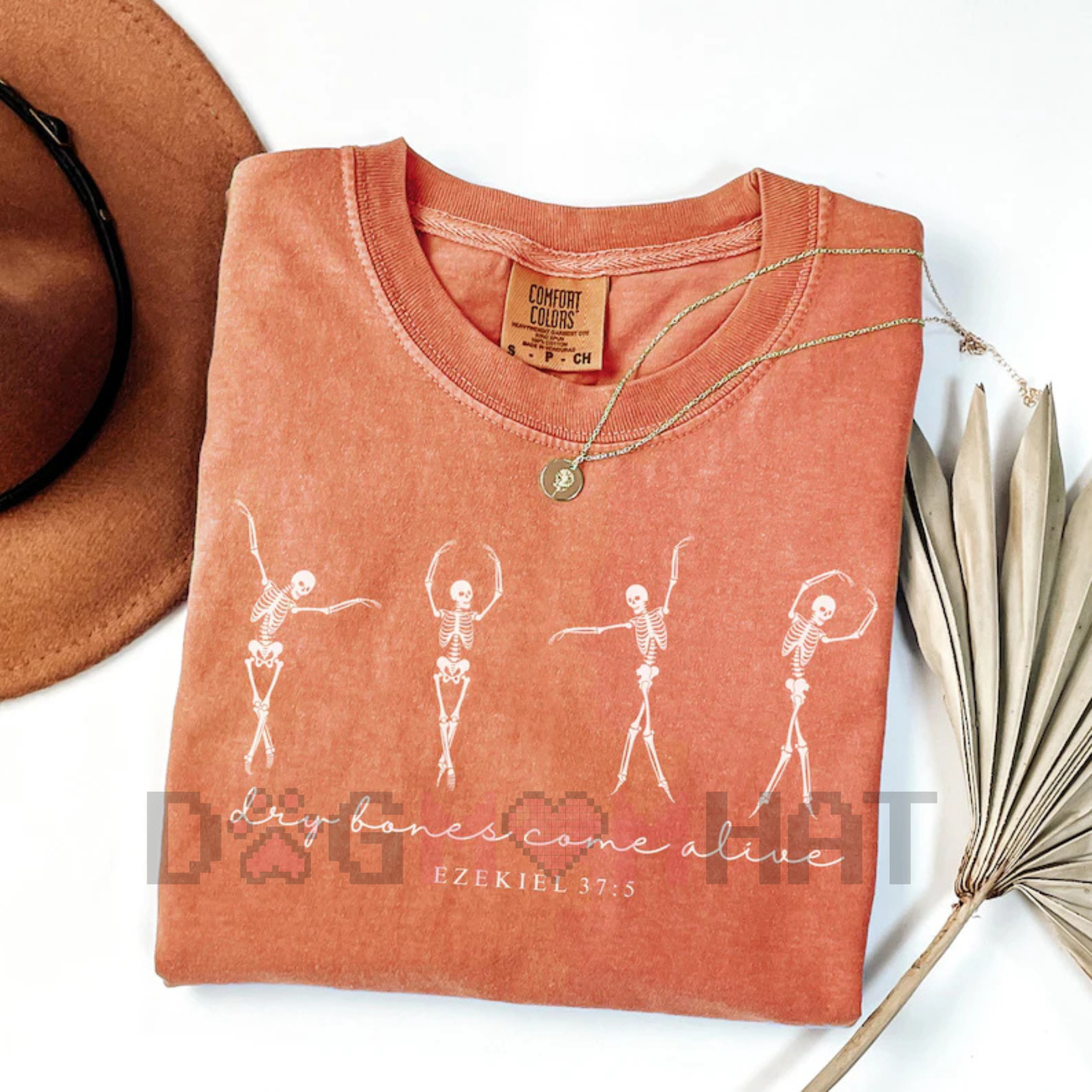Coral T-shirt with white dancing skeletons graphic and heart pixel detail