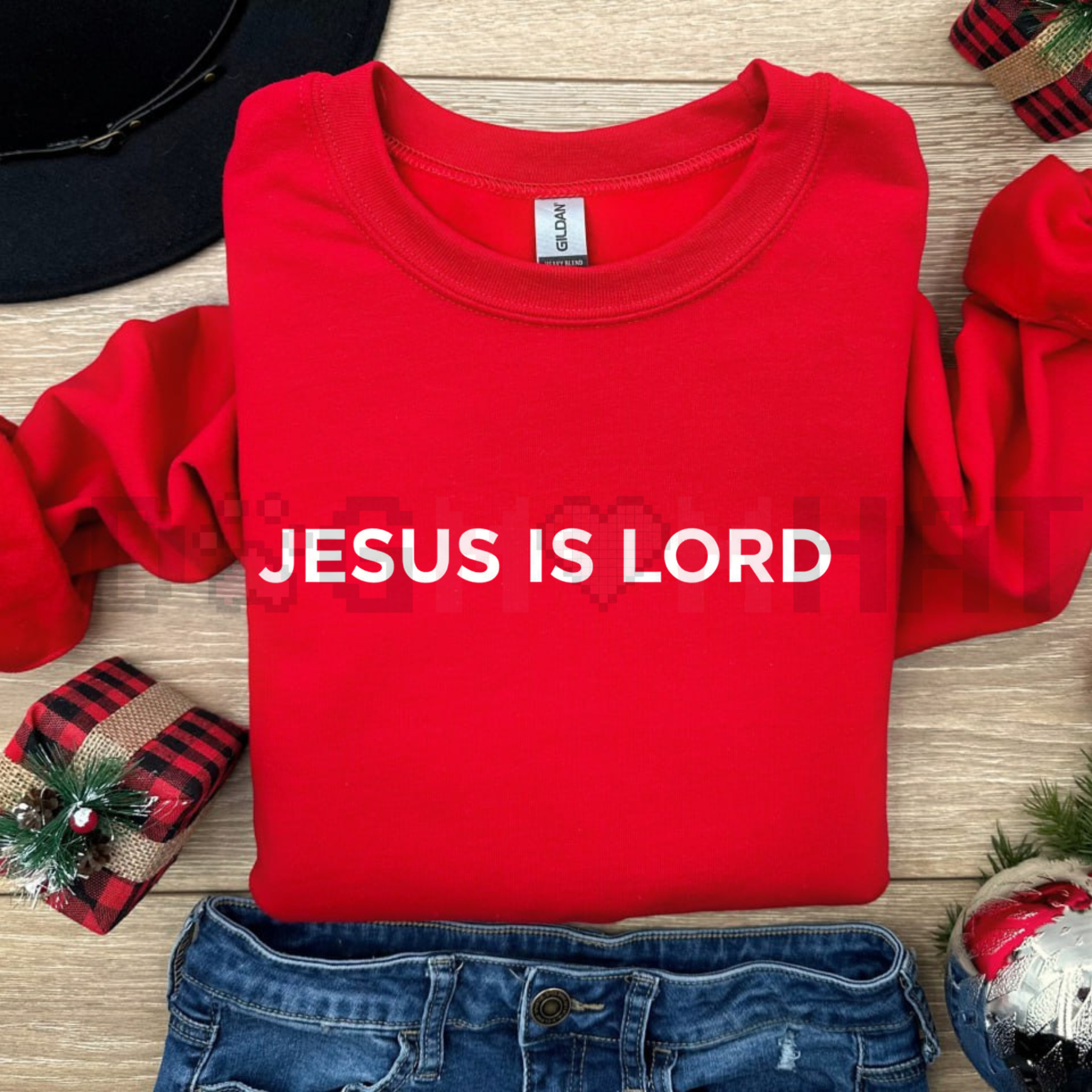 Red sweatshirt with white 'JESUS IS LORD' print, crew neck and long sleeves